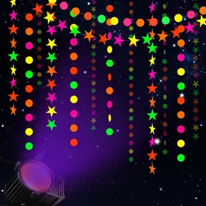 Close-up of neon star and circle paper garland showing fluorescent effect under UV light