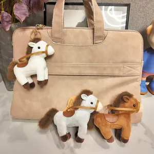 Detailed view of cute plush horse keychains in various colors on a beige handbag