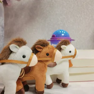 Detailed close-up showing three colorful plush horse keychains with cute bridles