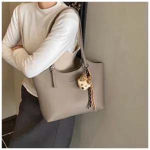 Stylish grey leather tote bag for women with commuting style and cute bear charm