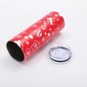 Close-up detail of a red 20oz Christmas insulated tumbler with festive patterns and lid.