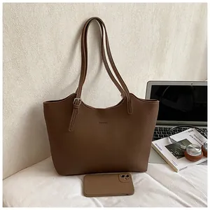Stylish vintage brown large capacity leather tote bag for women shown with everyday essentials