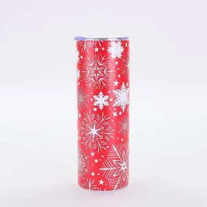 20oz skinny tumbler featuring festive white snowflake patterns on a vibrant red background