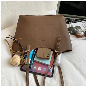 Large retro brown leather tote bag showing spacious interior with daily essentials