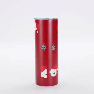 Close-up detail of a red Christmas tumbler with festive Santa pattern and clear lid