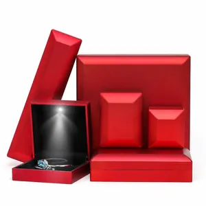 Luxurious red matte LED jewelry box for rings and necklaces with focused spotlight
