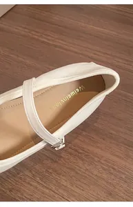 Close-up detail of soft breathable microfiber lining on white Mary Jane shoes