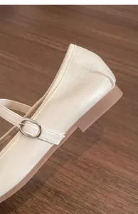 Close-up detail of pearl white French style Mary Jane shoes with stable low heel