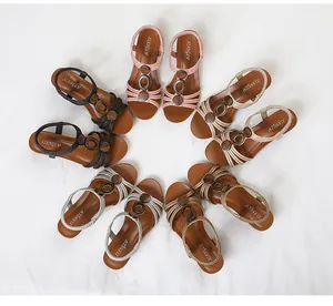 Detailed view of multiple colors of retro wedge Roman sandals with wooden bead decoration