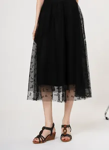 Wedge sandals for women with brown wooden sole and black straps paired with mesh skirt