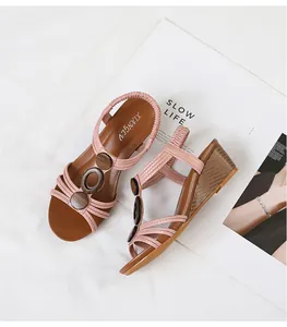 Close-up detail showing pink Roman wedge sandals with vintage wood-like accents