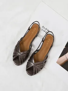 Detail von bronzemetallischen flachen Riemchensandalen mit Slingback-Design