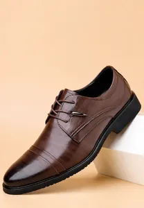 Vista ravvicinata di scarpe eleganti marroni da uomo con texture in pelle goffrata