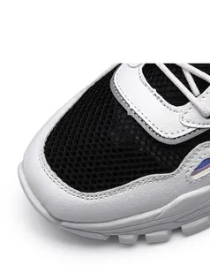 Close-up of breathable mesh and durable PU leather upper on a stylish white sneaker
