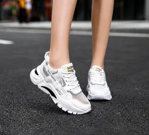 Detail shot of breathable white mesh sneakers for men featuring lightweight sport design