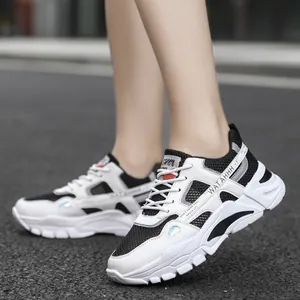Breathable men's sports sneakers in white and black with mesh design for casual wear