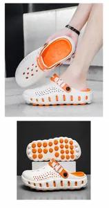 Detailansicht der leichten weißen Gartenschuhe mit orangefarbenen Sohlen und atmungsaktivem Design