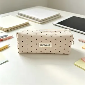 Detailed view of a minimalist star pattern canvas pencil case on a clean workspace desk.