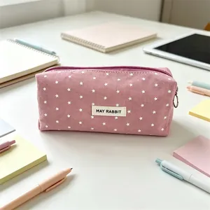 Detail of pink star-patterned canvas pencil case with 'MAY RABBIT' label