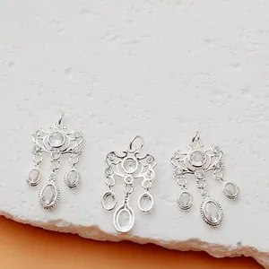 Detailed view of ornate silver-plated floral pendants with clear CZ stones for DIY jewelry