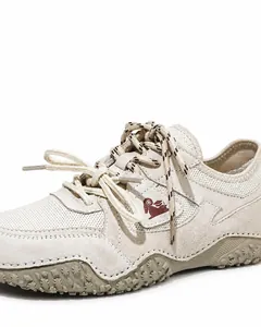 Close-up of outdoor leather sneakers featuring double shoelaces and hand-stitched sole