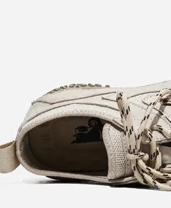 Macro view of the breathable mesh lining and soft interior of the leather outdoor casual sneakers
