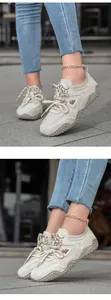 Side view of beige outdoor sneakers featuring leather panels and unique nubbed outsoles.