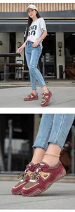 Outdoor casual sneakers in burgundy with textured rubber soles on street