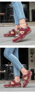 Side view detail of maroon leather outdoor casual sneakers with non-slip studded sole