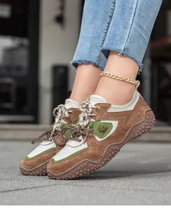 Close-up of brown suede outdoor casual shoes with mesh panels and non-slip soles