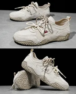 Side detail of cream leather outdoor casual sneakers with textured soles