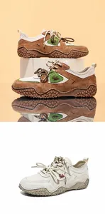 Stylish brown and white outdoor casual leather sneakers featuring mesh panels and textured soles