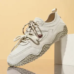 Beige outdoor casual shoes with leather and mesh panels for breathable summer wear