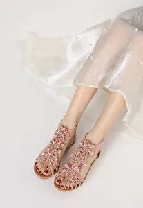 Close-up view showing the floral detail of pink Bohemian wedge sandals for summer.