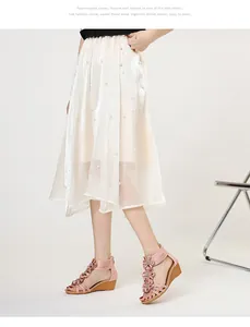 Close-up detailed side view of pink Bohemian wedge sandals with 3D flower decorations