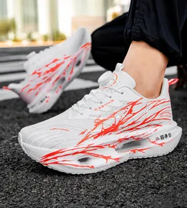 Detailed view of white running shoes with red patterns and shock-absorbing hollow sole