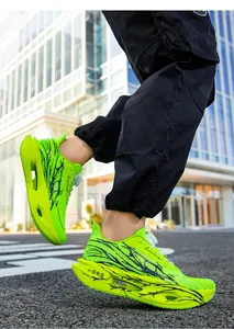 Side view of neon green breathable mesh running shoes with black graphic patterns