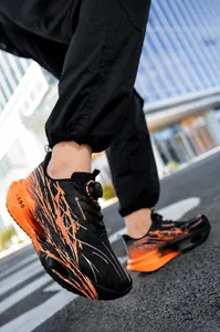 Close-up of black and orange breathable mesh running shoes with cushioned popcorn sole