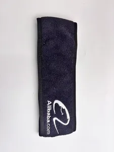 Macro view of navy blue microfiber spa headband featuring a white embroidered brand logo