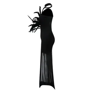 Side view of a sexy black bodycon maxi dress with feather accents and mesh hem