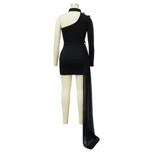 Rear view of black one-shoulder mini dress featuring a long sheer mesh train.