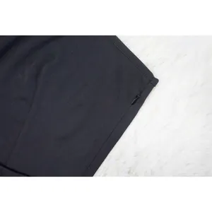 Macro view of the high-quality hidden side zipper on a black off-the-shoulder dress