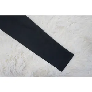 Detailed view of the black long sleeve cuff and smooth fabric texture on a women's dress