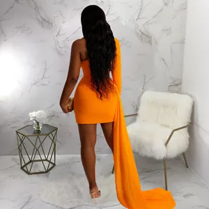 Back view of a vibrant orange one-shoulder mini dress with a long elegant train