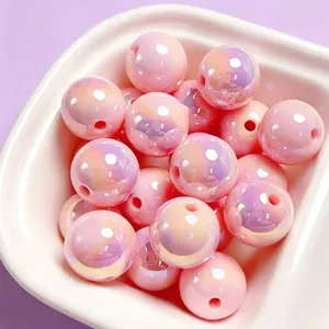 Close-up of pink iridescent acrylic beads with UV coating for DIY jewelry making