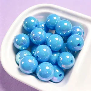 Close-up detail of 16mm light blue iridescent acrylic beads for DIY handmade jewelry