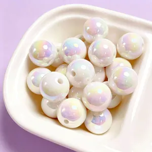 Detailed macro view of 16mm iridescent UV plated white acrylic beads in a ceramic bowl