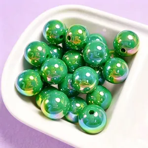 Macro view of 16mm green iridescent UV plated acrylic beads for DIY jewelry making