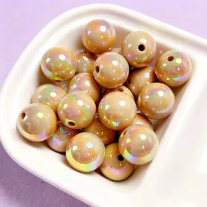 Close-up of iridescent champagne UV-plated acrylic beads with smooth rainbow finish