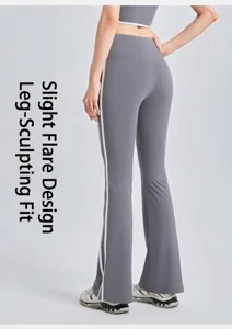 Close-up of grey high-waisted flare yoga pants with white side stripes.
